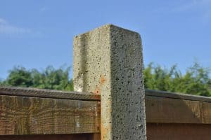 A concrete post holding a fence panel, Will A 4 x 4 Fit In A Cinder Block?