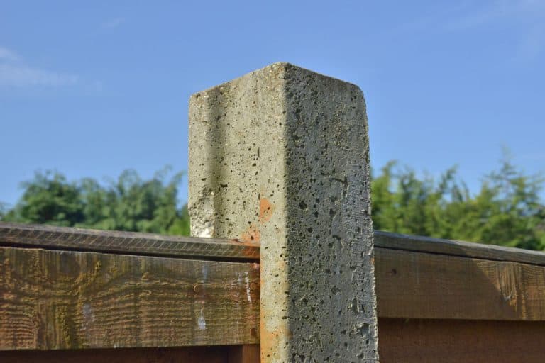 A concrete post holding a fence panel, Will A 4 x 4 Fit In A Cinder Block?