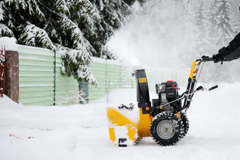 A man is cleaning the country road with snow blower in winter, My Cub Cadet Snow Blower Is Not Starting After Summer - What To Do?