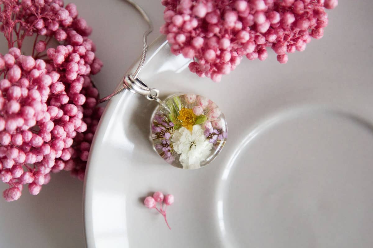 A necklace made from preserved flowers in resin