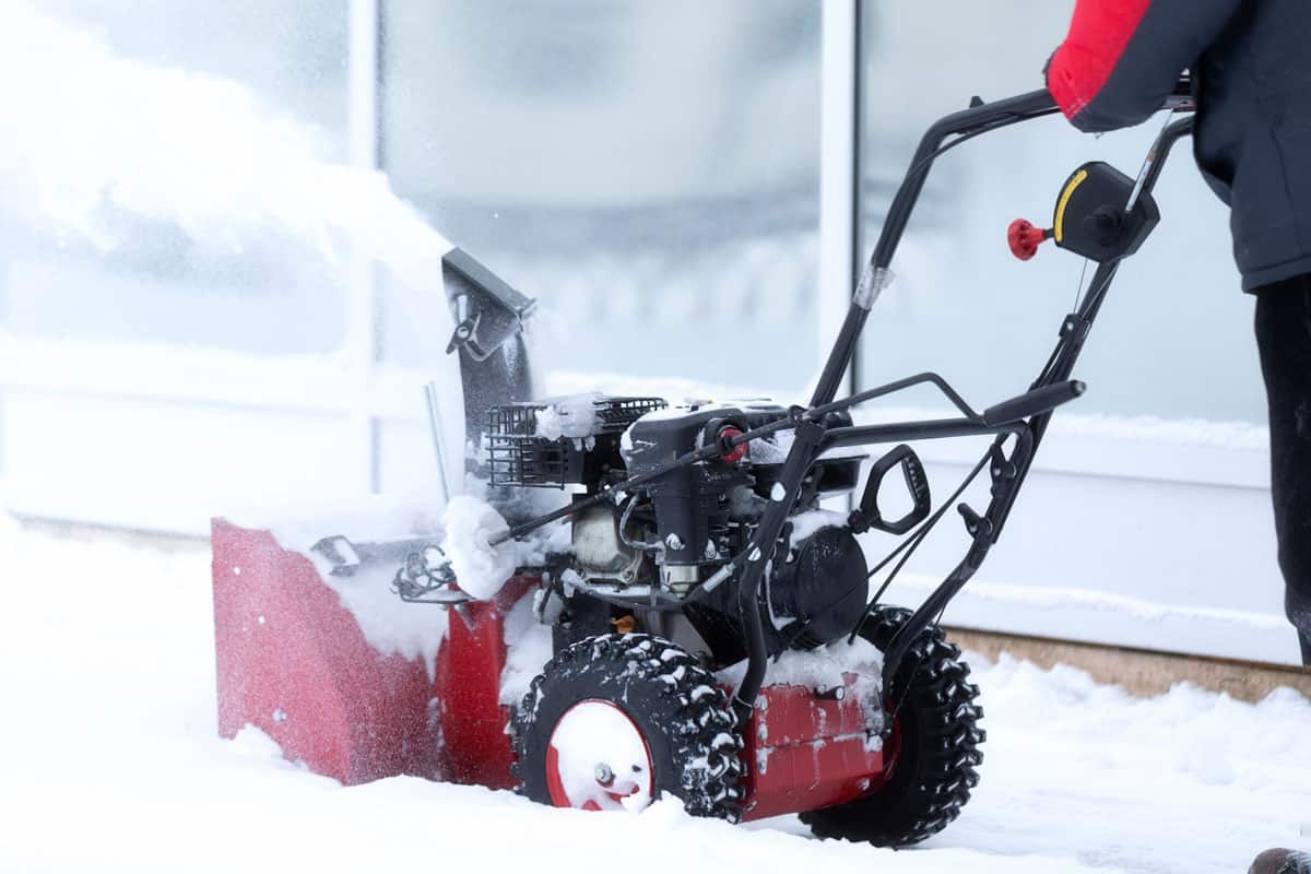 A portable snow blower powered by gasoline. Snow removal in winter