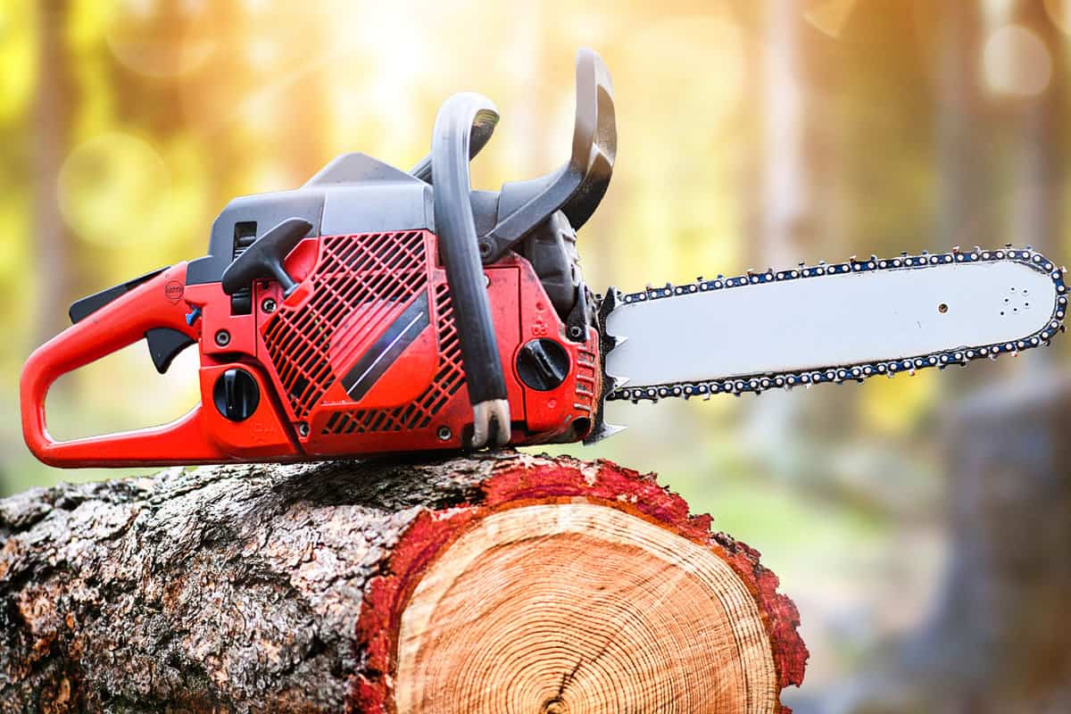 Chainsaw on wooden stump or firewood. Cut tree machine wide banner