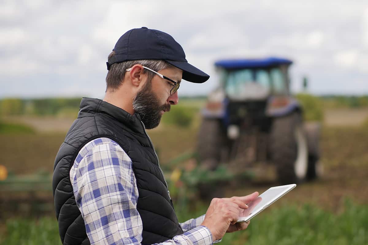 Farmer uses a specialized app on a digital tablet