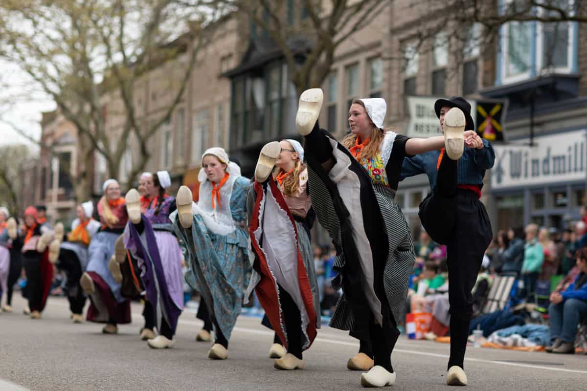 Tulip Time Festival, Young women wearing traditional Dutch Clothing dancing in the streets of Holland