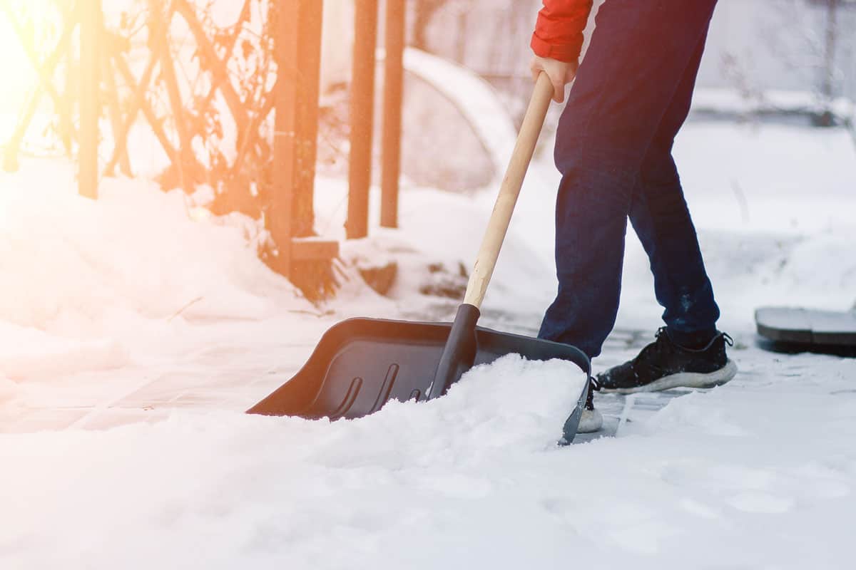a public service worker in a single shovel snow in the winter blizzard