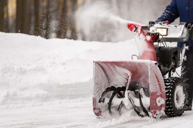 man red snow covered snow blower clears, How To Start A Troy Bilt Snow Blower
