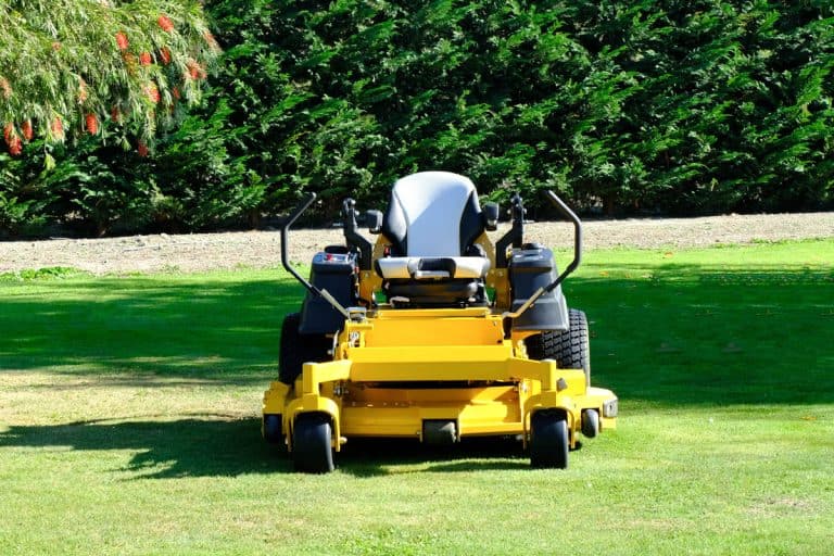 yellow zero-turn mower parked in the middle of the green grass field, Zero-Turn Mower Not Working On One Side - Why? What To Do?