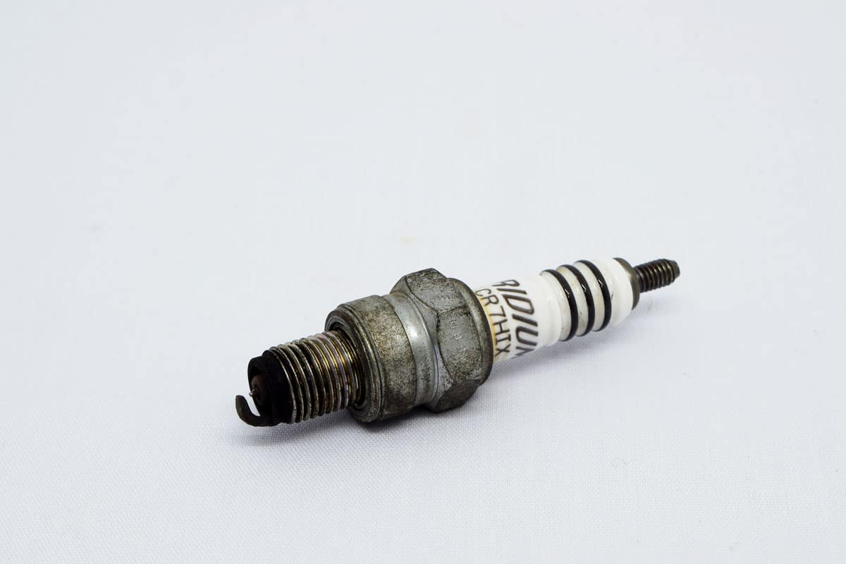Dirty spark plug on a white background