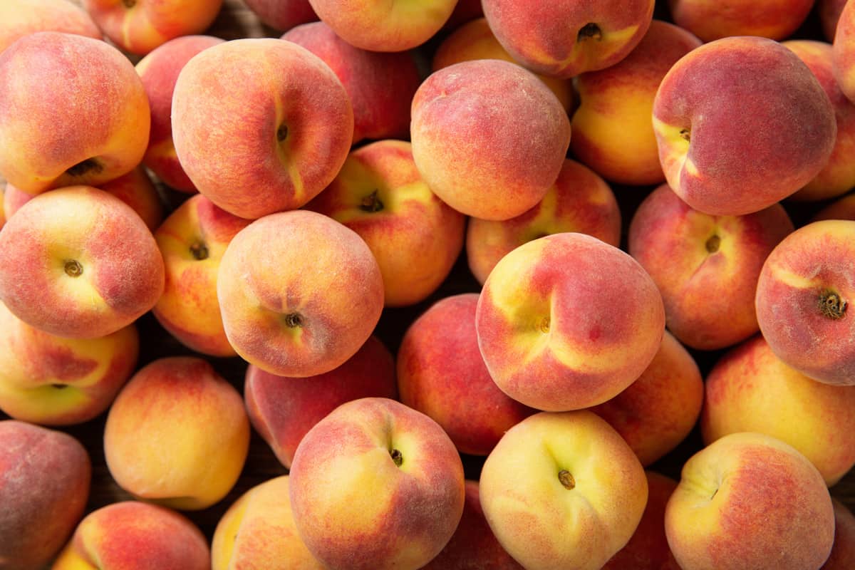 fresh ripe peaches as background, top view