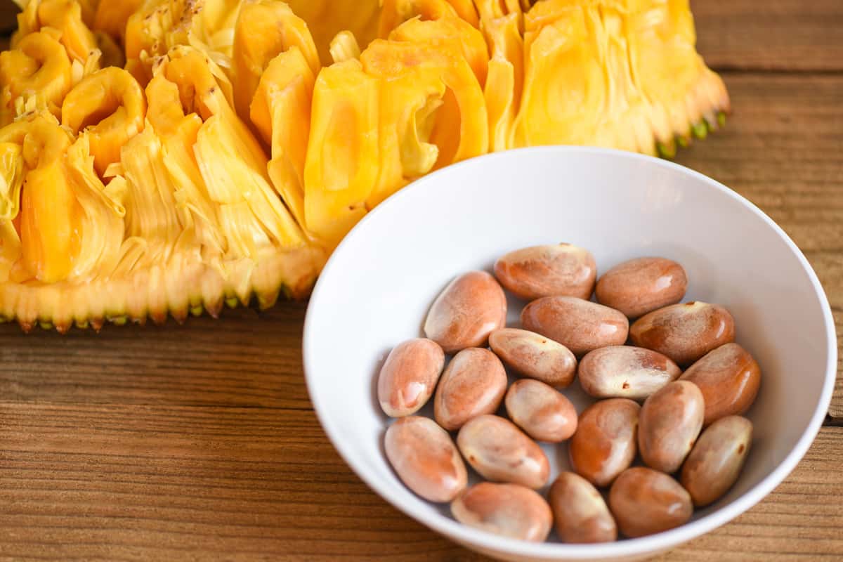 Jackfruit seed on white bowl on a wooden background