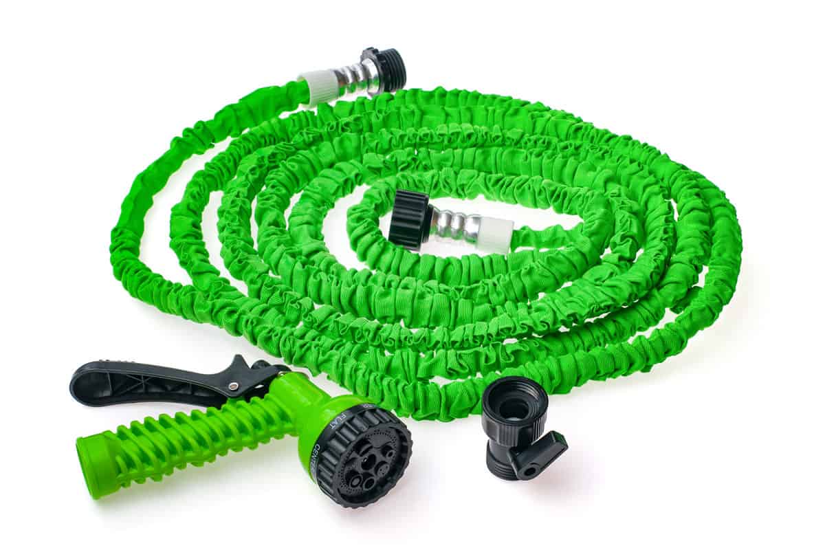 Green expandable hose isolatd in white background