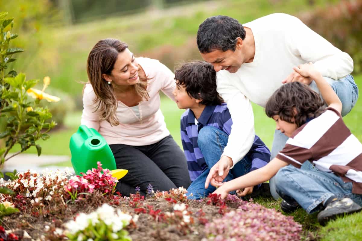Happy family gardening together and taking care of nature