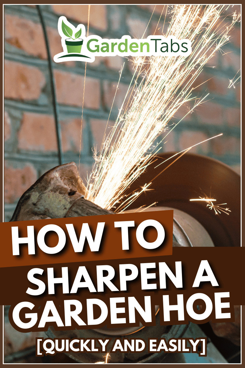 farmer sharpens garden tool on electric grindstone in rural shed. - How To Sharpen A Garden Hoe [Quickly And Easily]