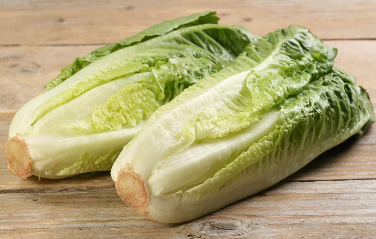 two hearts of romaine lettuce on a rustic wooden board