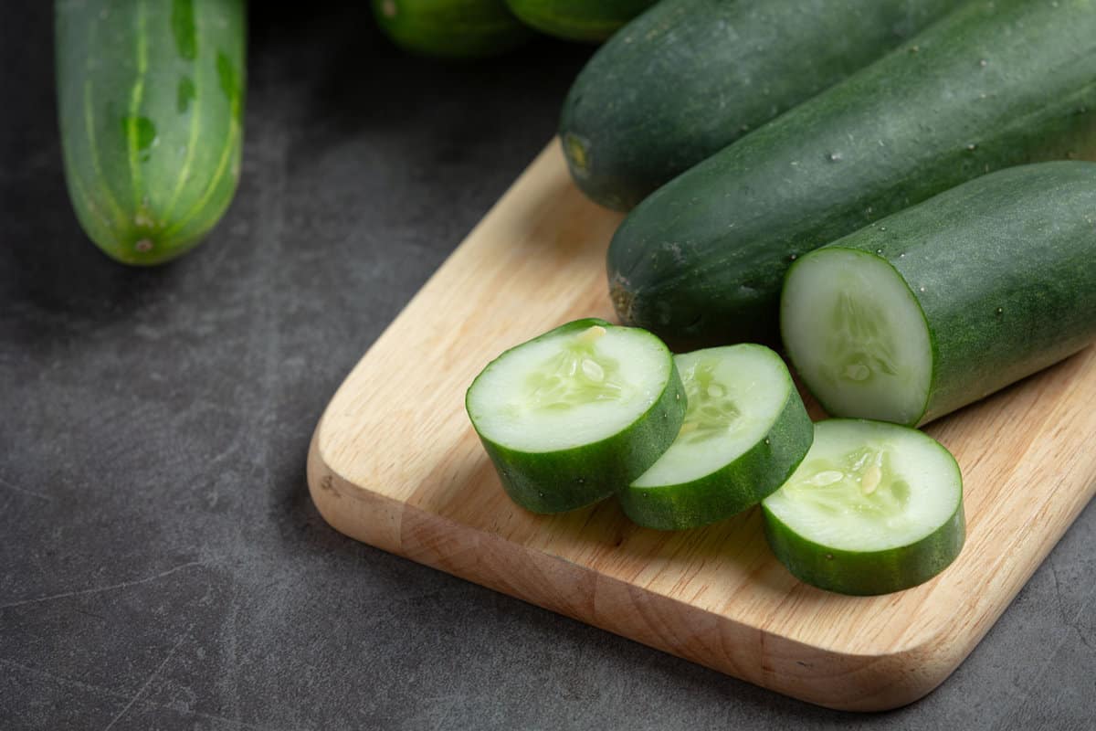 Freshly sliced cucumbers on a chopping board