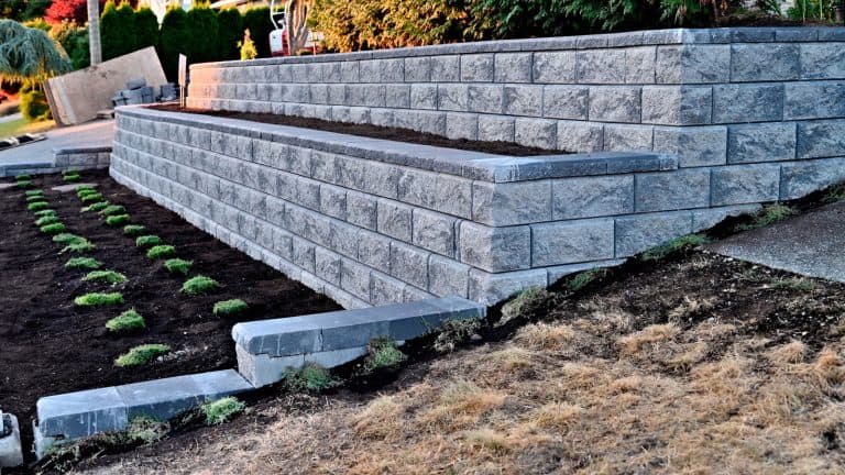 A stone retaining wall in the garden, Can You Use Tires For A Retaining Wall? Thinking Outside The Box In Landscaping - 1600x900