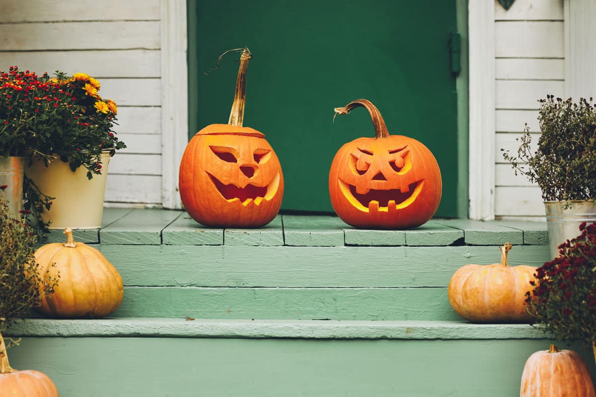 A green porch with pumpkin decorations