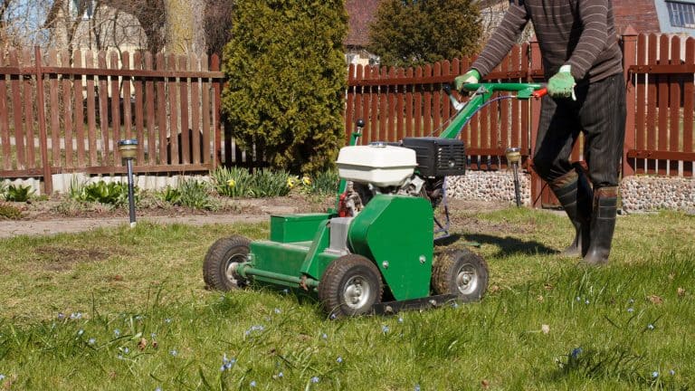 Gardener using a Ryan aerator in the garden, How To Start A Ryan Aerator [Step By Step Guide] - 1600x900