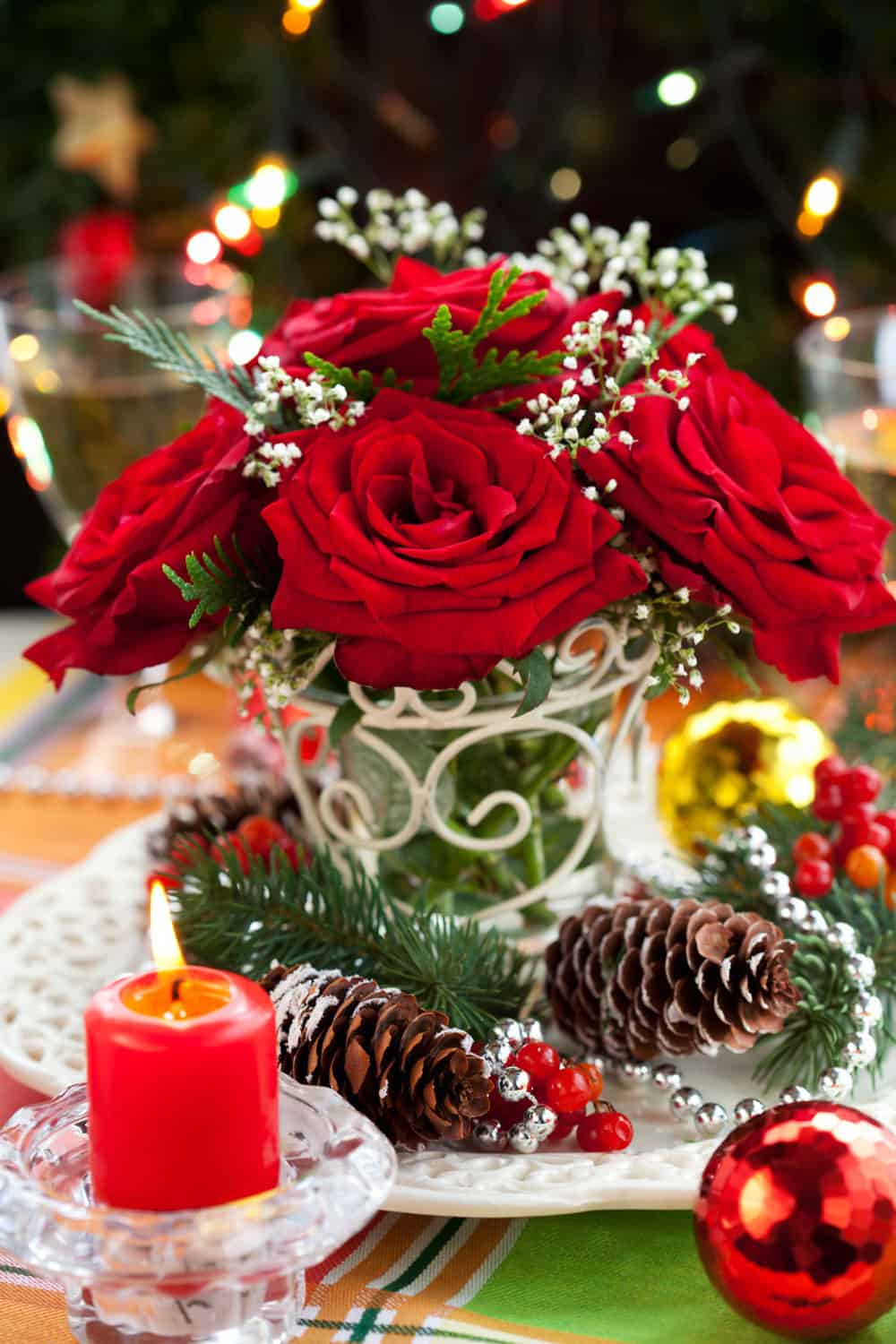 Christmas arrangement of red roses,fir, holly and pine cones