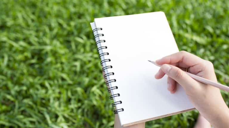 Woman writing on her gardening journal, Seasonal Planning Using Your Gardening Journal to Plan Each Season - 1600x900