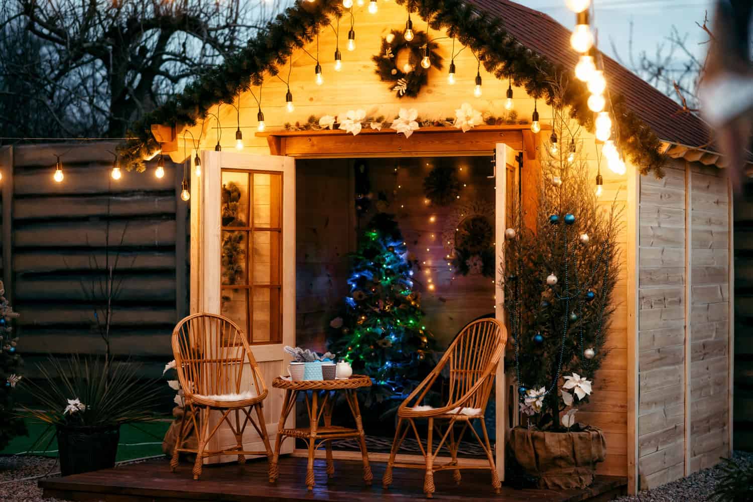 A small cabin filled with lights and other Christmas themed decors