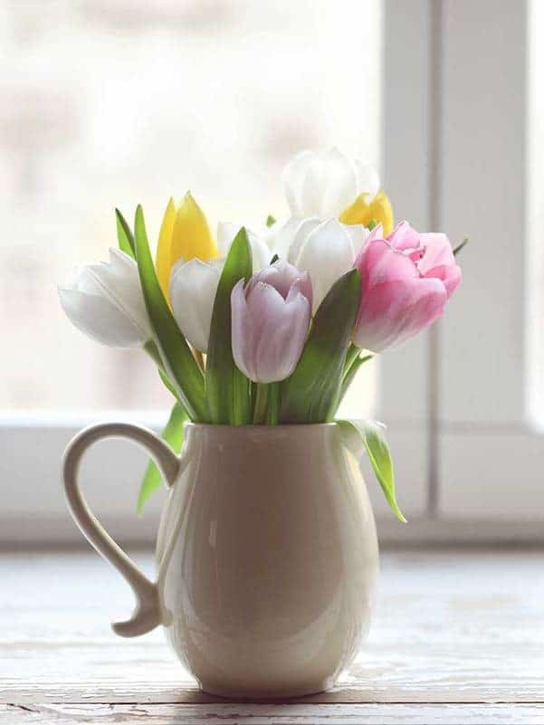 Colorful bouquet of tulips on a jar vase ar 3:4